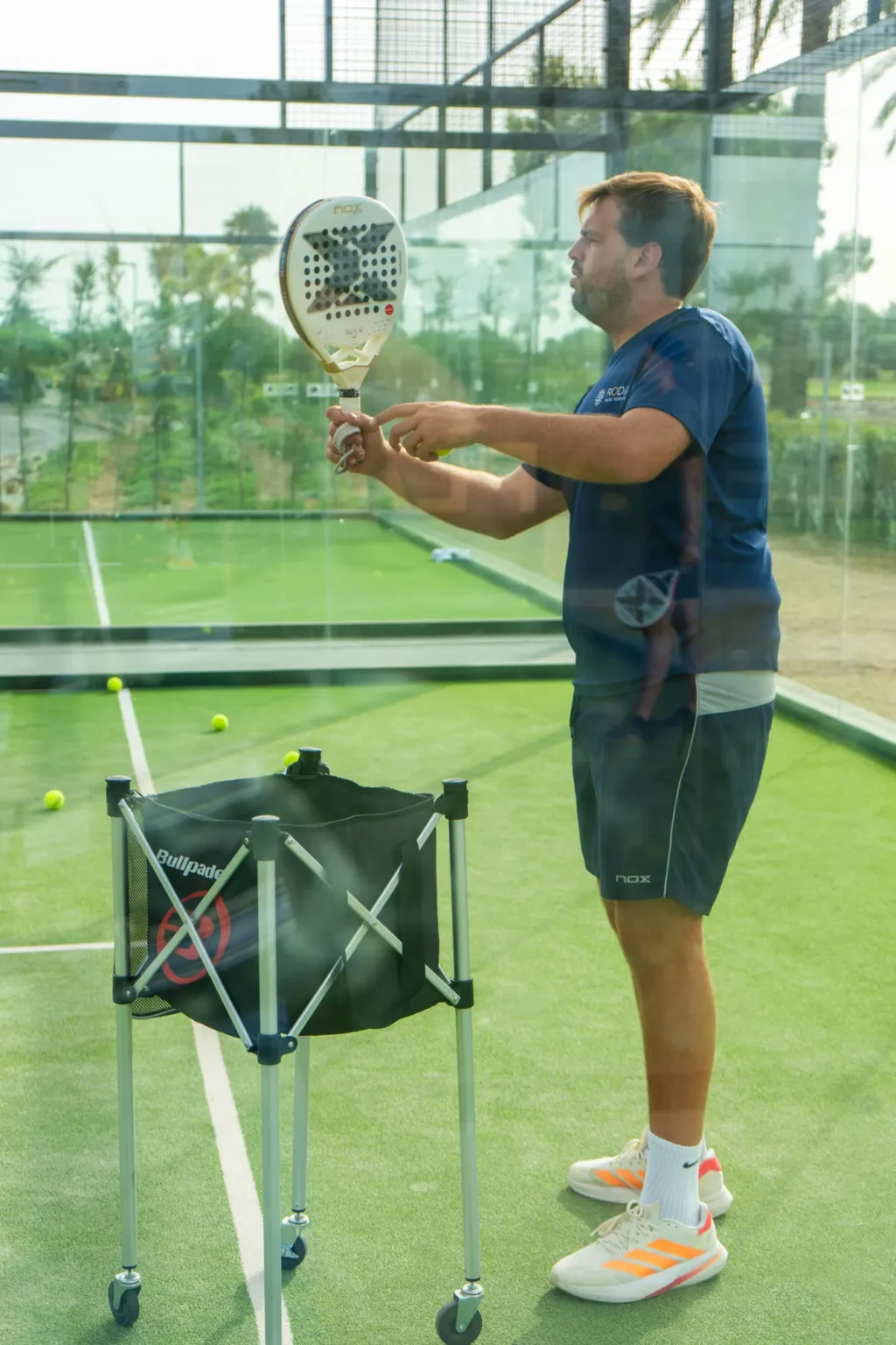 Getting a lesson ready with a ball cart at Roda Padel Reserve