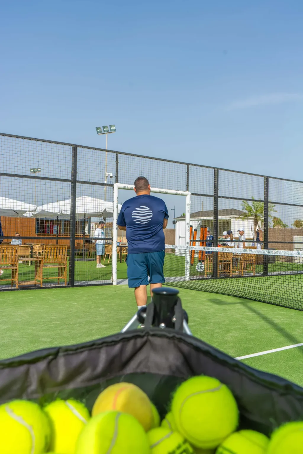 Basket of padel balls on the court