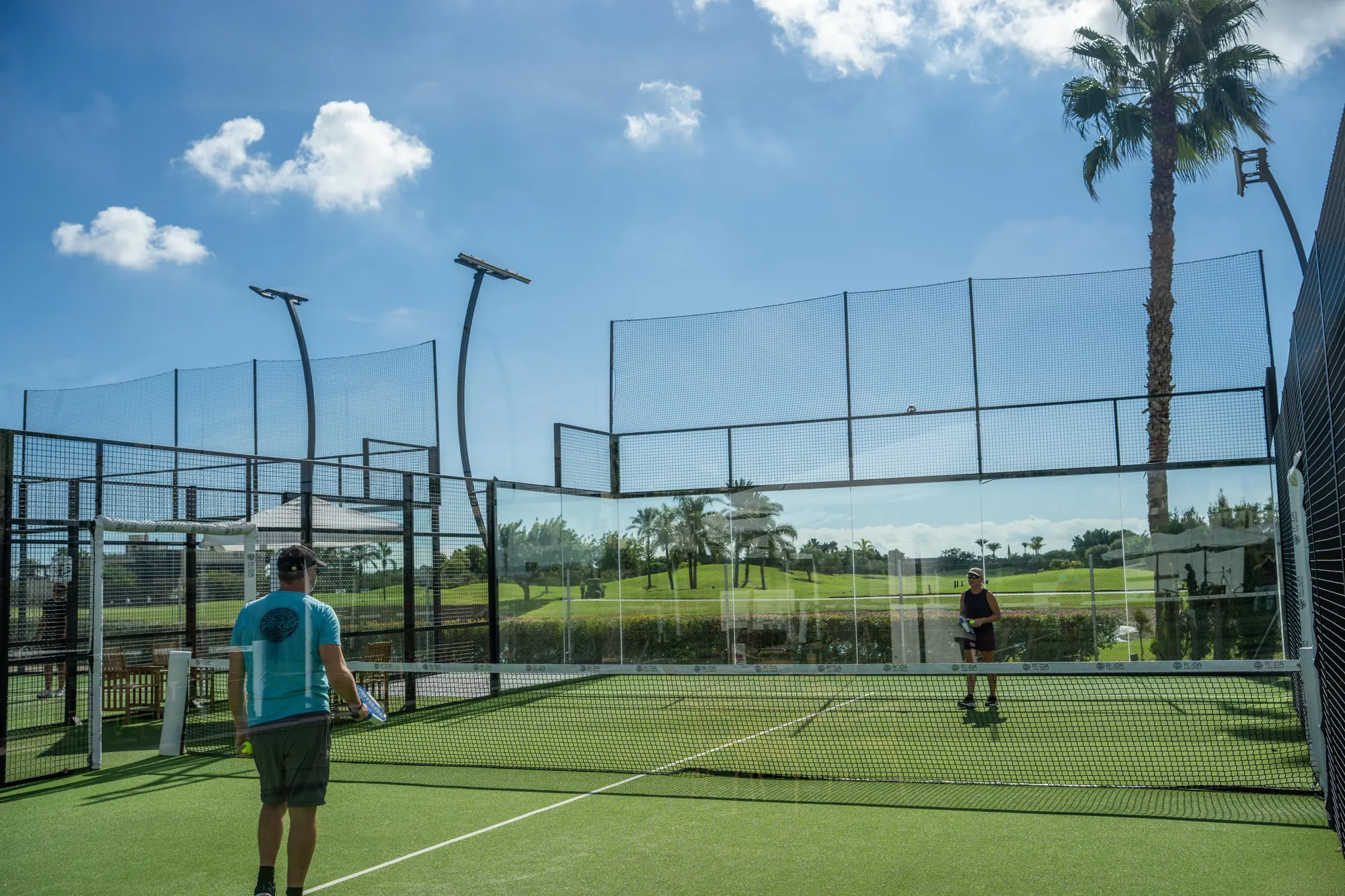 Player on a glass court at Roda Padel Reserve