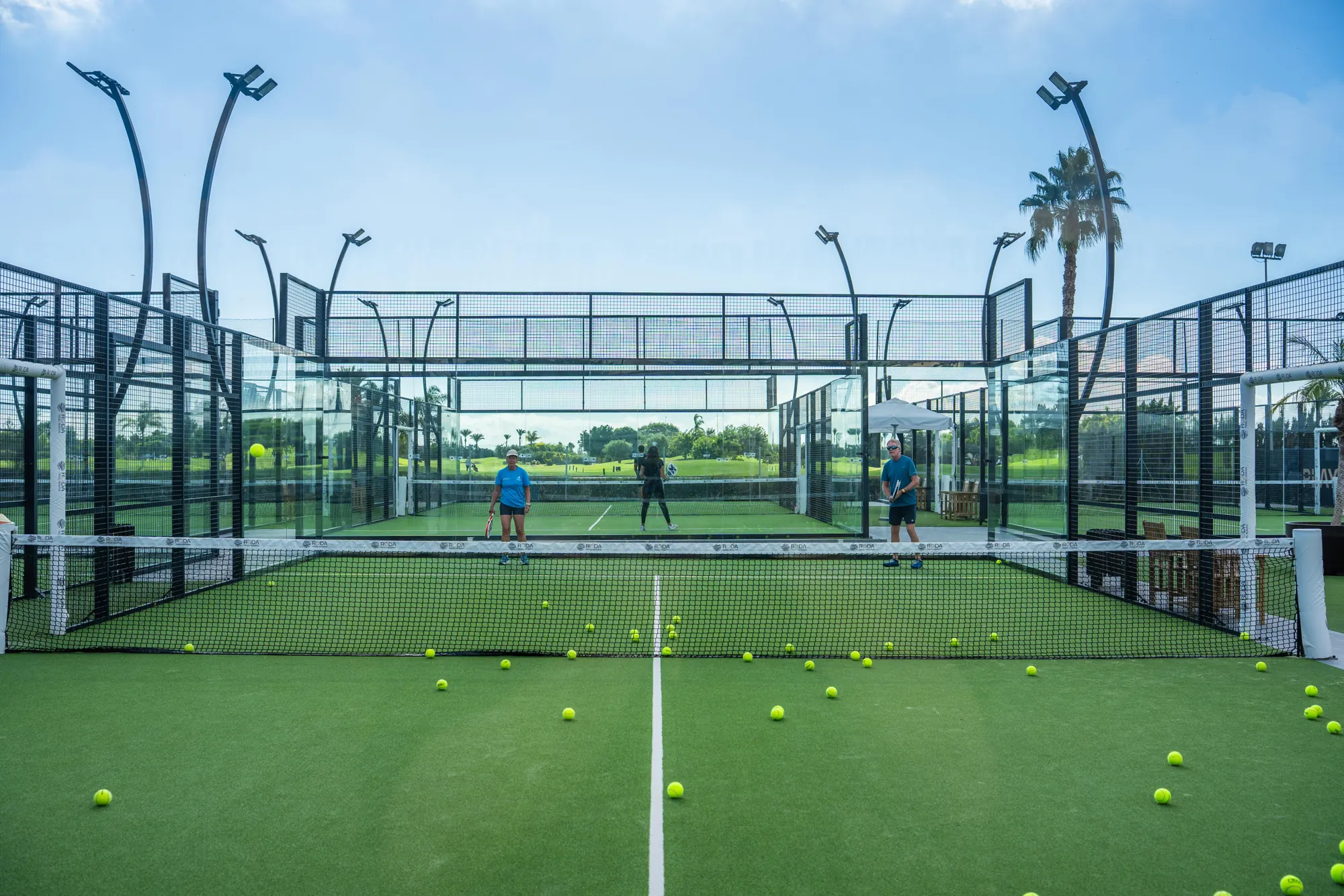 Glass court with balls on the artificial grass